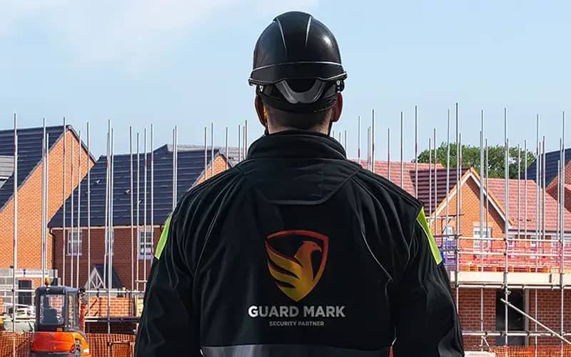 Construction site security guard performs duties at the construction site, ensuring safety and security effectively.