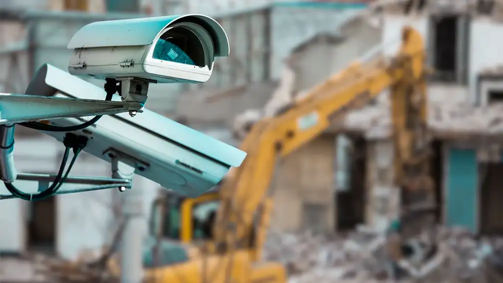 A construction site with multiple CCTV cameras installed for security monitoring. The cameras overlook the site, ensuring safety and surveillance
